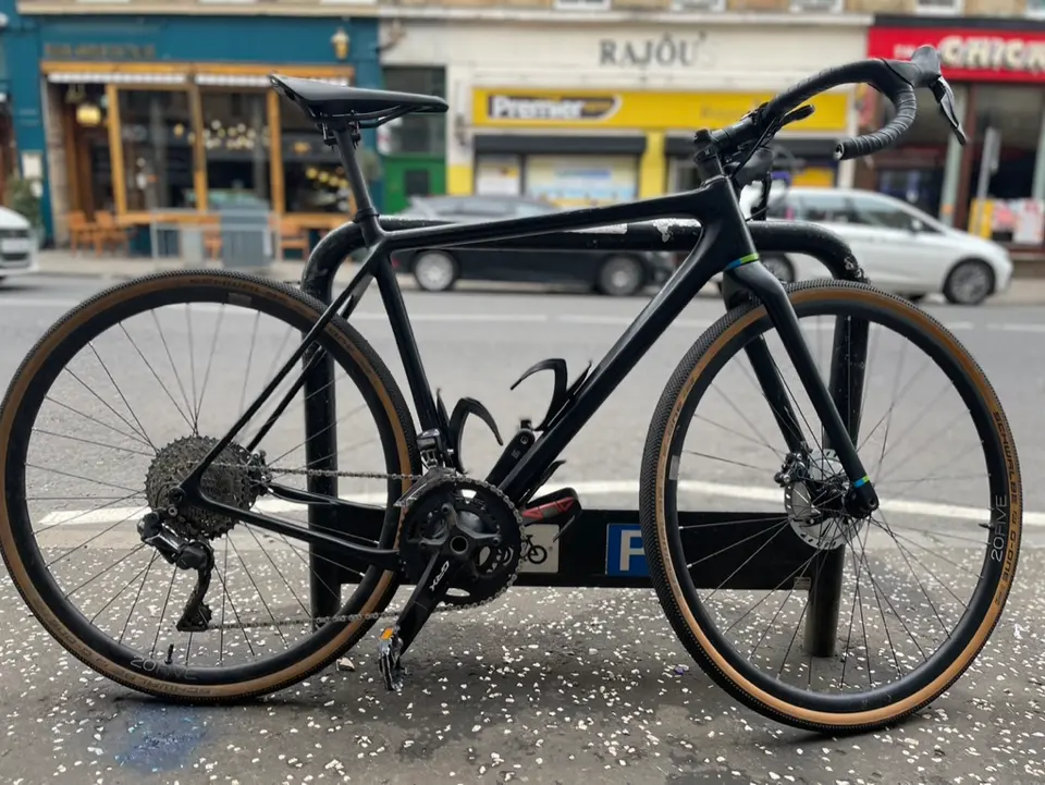 Two black gravel bikes side by side on Gibson Street