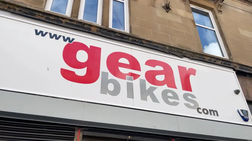 The big red and grey www.gearbikes.com sign above the shop on Gibson Street