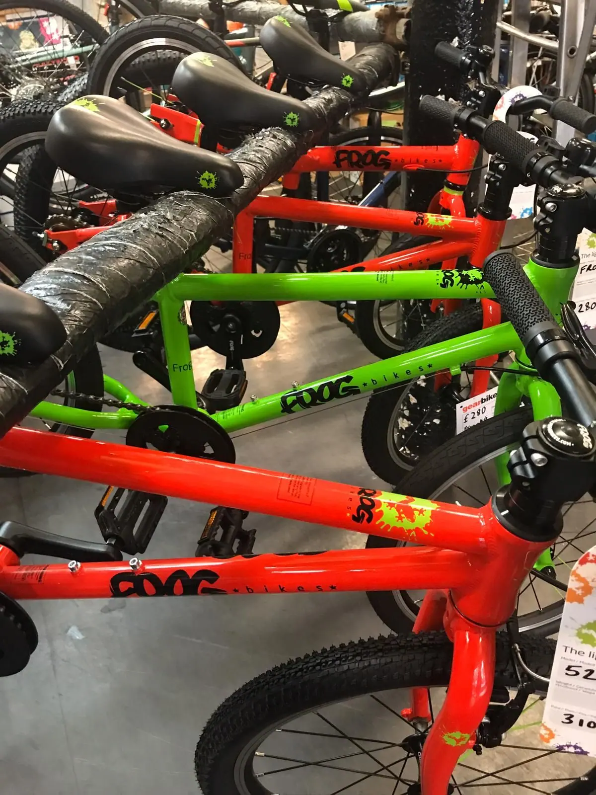 Red and green children's bikes on the shop floor