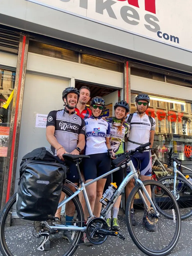 Riders with a loaded hire bike outside the shop