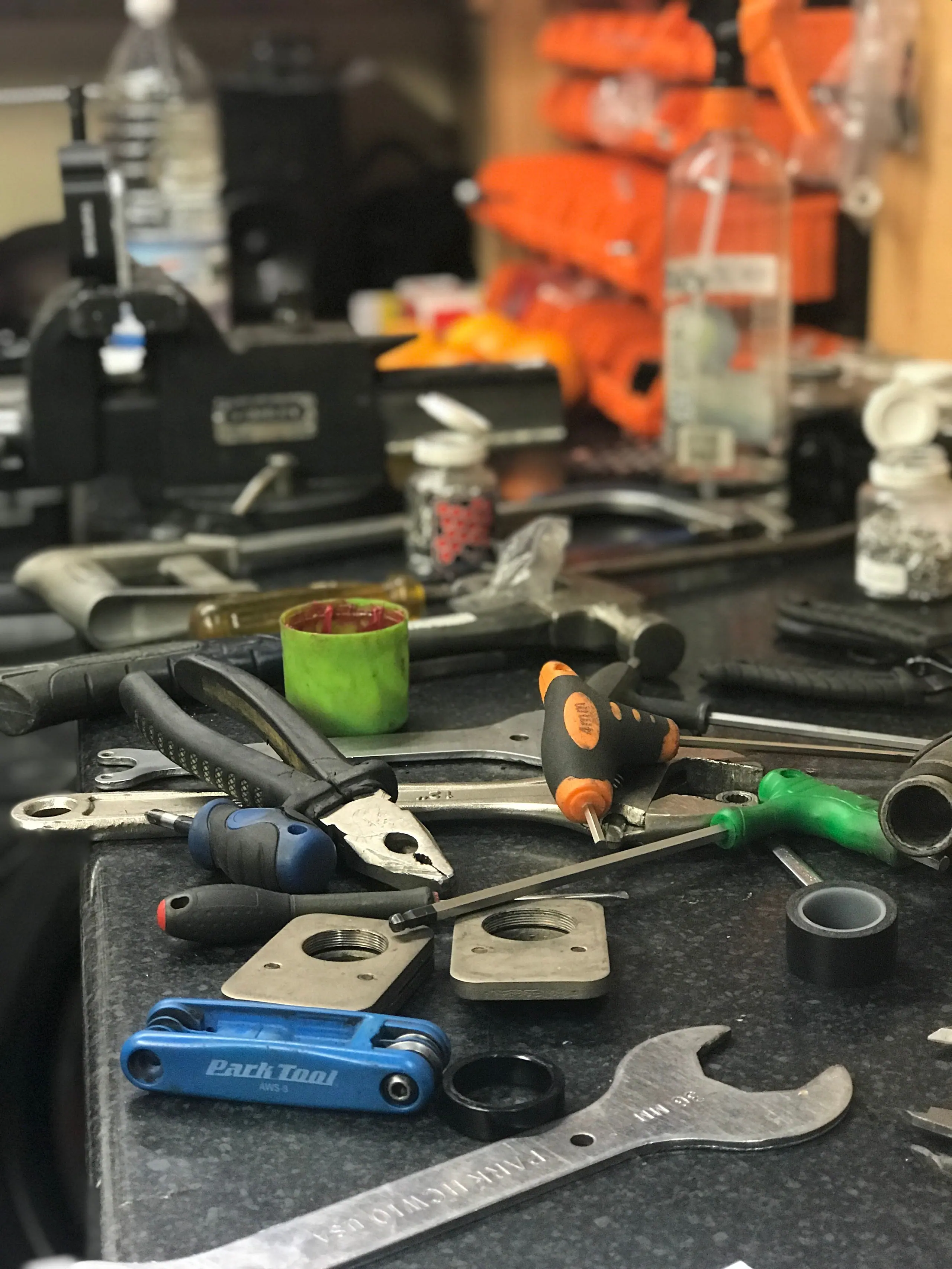 Tools and parts laid out on the Gear Bikes workshop bench